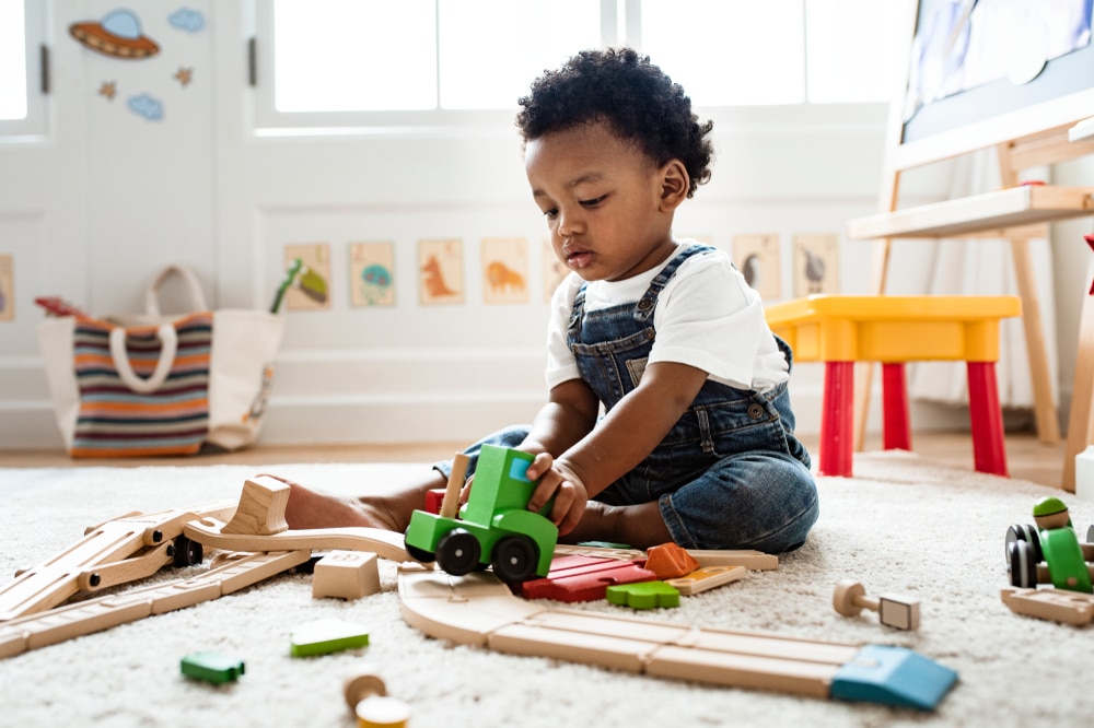 Cute,Little,Boy,Playing,With,A,Railroad,Train,Toy