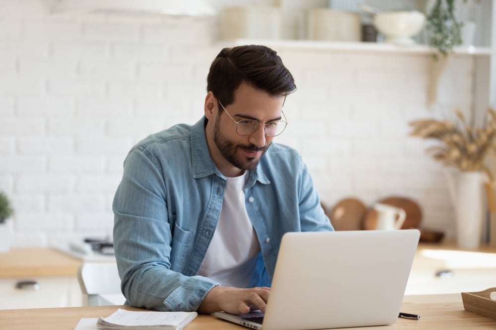 Head,Shot,Young,Businessman,Sitting,At,Table,With,Computer,,Working