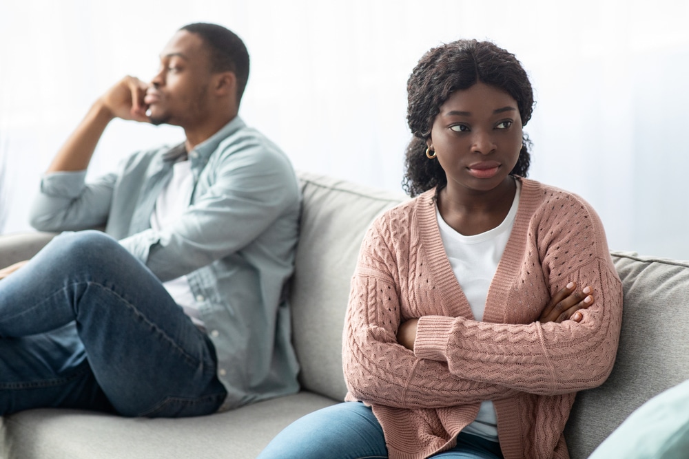 Angry,Black,Woman,Sitting,Apart,From,Her,Frustrated,Boyfriend,,Young